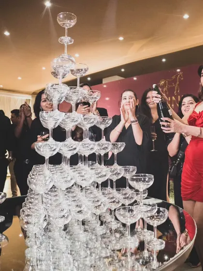 The celebratory pop of a champagne bottle over the tower, a peak moment of fun and festivity captured at the event.