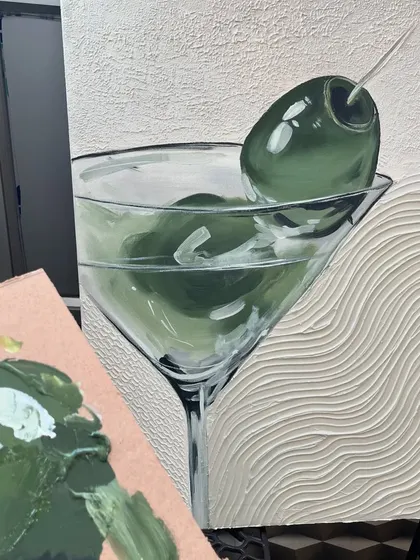 A behind-the-scenes look at the martini painting next to my paint palette, showing the shades of green used.