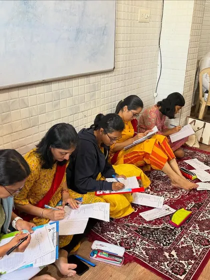 Our students diligently writing their theory exams on the floor, in a traditional gurukul style, at our Bangalore centre.