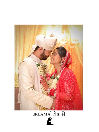An intimate moment between the bride and groom at their wedding ceremony, their faces close together.