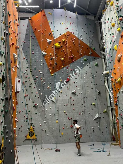 A wide shot of our gym during the CPL, with climbers scaling different routes. This shows the dynamic environment of the competition, with multiple challenges happening at once.