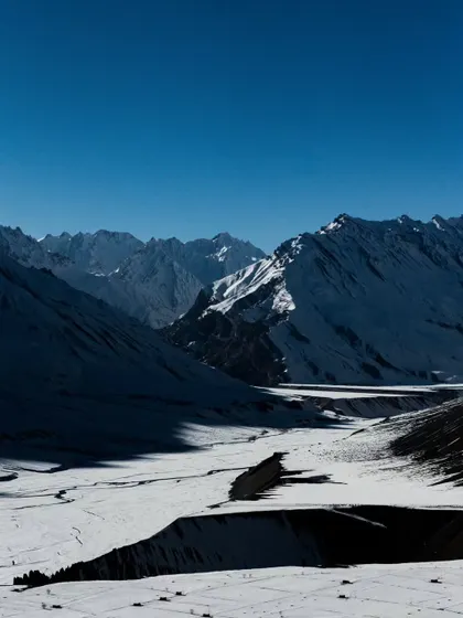 A vast, snow-covered valley in Spiti, showing the immense scale and quiet emptiness of the winter landscape.