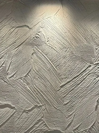 A close-up of a hand-applied textured finish, showing the depth and character created by abstract brushstrokes.