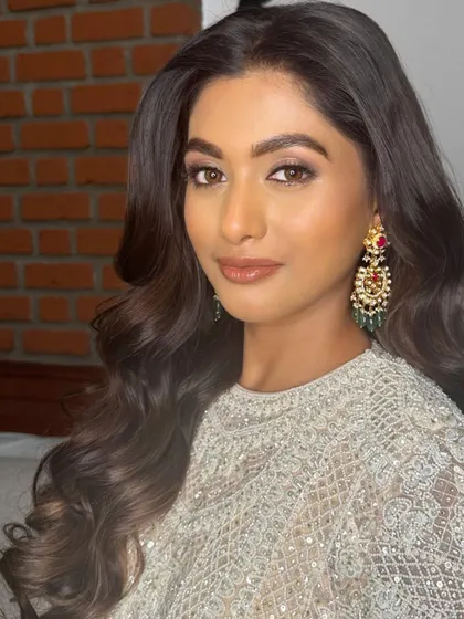 A close-up of the reception makeup, highlighting the beautiful brown smokey eye and glossy lip.