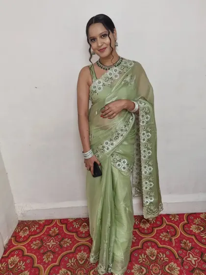 A full-length shot of this elegant party look. The light green saree and simple makeup are perfect for a daytime or evening event.