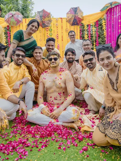A happy group photo of the groom with his friends and family after the haldi rituals. It's a perfect memory of the people who celebrated with him.