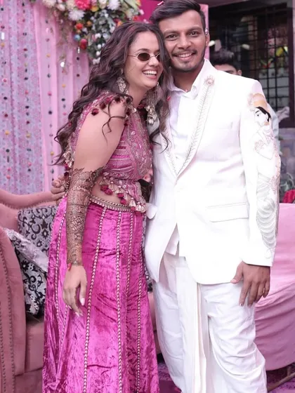 A fun and candid shot of the Mehendi bride with her groom. Her modern outfit and cool sunglasses show off her playful personality.