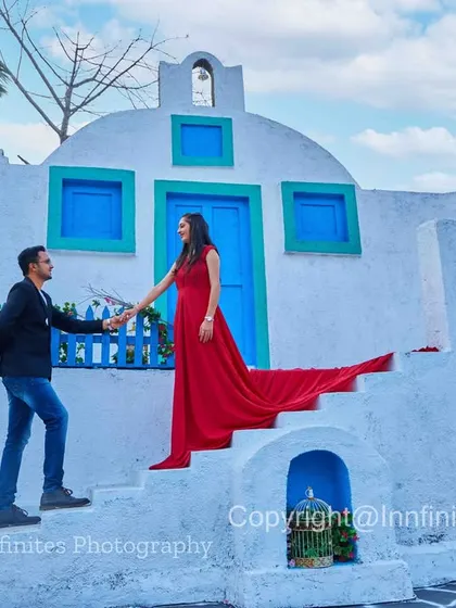 The long trail of a red gown adds a splash of color and drama to this shot on the steps of our Greek-style set.