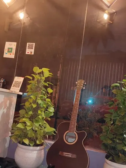 A quiet corner of our academy, with a guitar waiting for its next player. Our space is designed to inspire creativity.