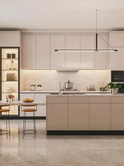 A minimalist island kitchen in a soft beige palette. The clean lines, handleless cabinets, and a simple island with seating create a serene and highly functional cooking environment.