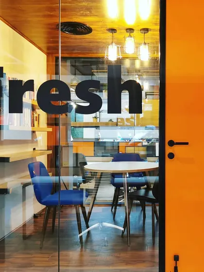 A close-up of the "Fresh" meeting nook, viewed through a glass door. This small, informal space is designed to "brew fresh ideas," encouraging creative thinking and spontaneous collaboration.
