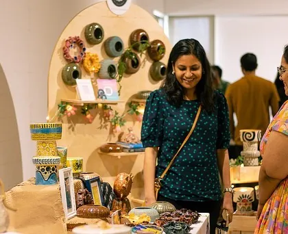 A student discussing her work with a visitor at GLAZED '22. The exhibit is a wonderful opportunity for our potters to connect with art lovers.