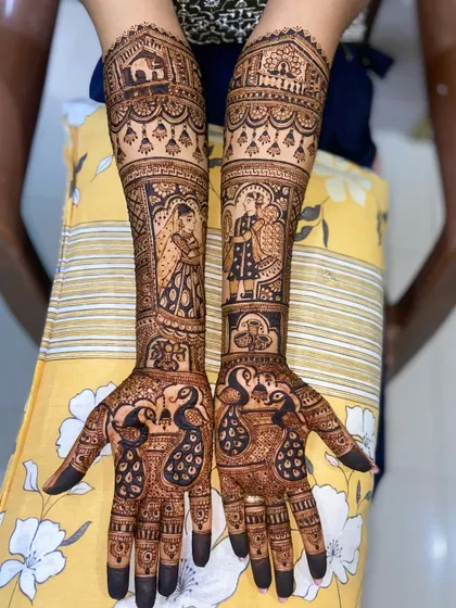 A full bridal design featuring portraits of a bride and groom, along with peacocks on the palms. The arms depict a wedding procession with a doli.