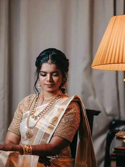 A seated portrait of the bride, looking peaceful and radiant. The soft lighting and her calm demeanor make for a beautiful and classic bridal photo.