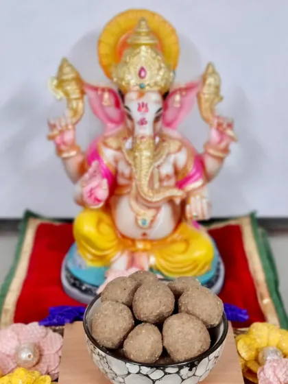 A bowl of our homemade Churma Ladoos offered to Ganpati Bappa. These are a festive favorite, and we take orders to help you celebrate with traditional sweets.