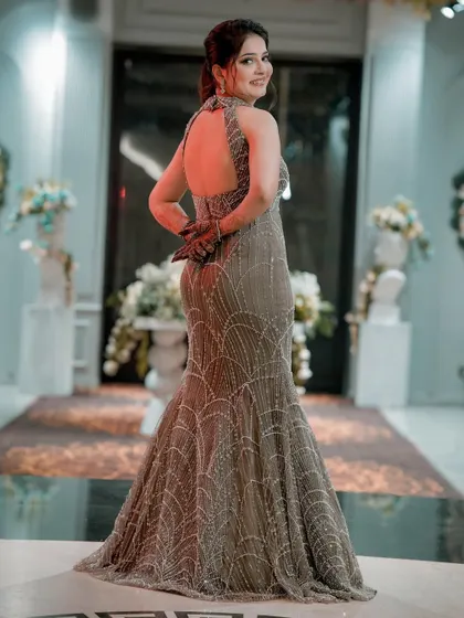 A stunning back-shot of the bride in her form-fitting, embellished gown, highlighting her style and grace.