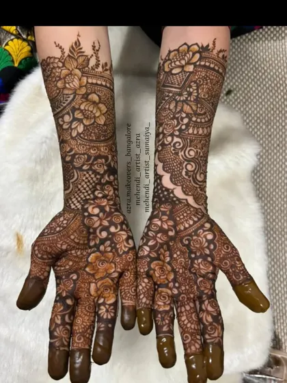 This design combines bold Arabic-style flowers with intricate Indian patterns for a stunning fusion bridal look.