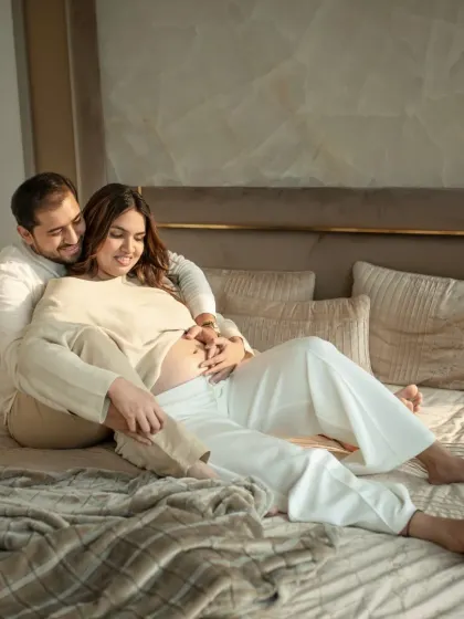 Another beautiful moment from a lifestyle maternity session. The soft natural light and comfortable setting on the bed create a feeling of peace and domestic bliss.