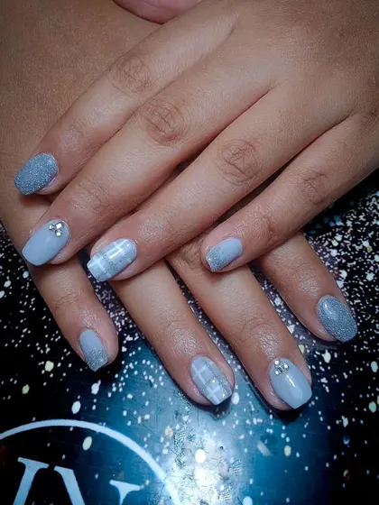 A chic and cozy design in a soft grey, featuring a mix of glitter, plaid pattern, and rhinestone accents.