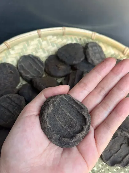 This is Anishi, the key ingredient for our traditional black curry. These are patties of smoked and dried taro leaves, a rare delicacy from the Ao Naga tribe that gives the curry its distinct color and flavor.