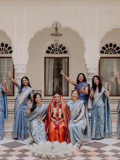 A fun and celebratory group photo of the bride and her bridesmaids, all cheering for her big day.