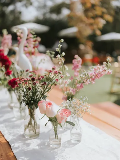 A close-up of the delicate floral arrangements used for a daytime event, featuring soft pinks and whites.