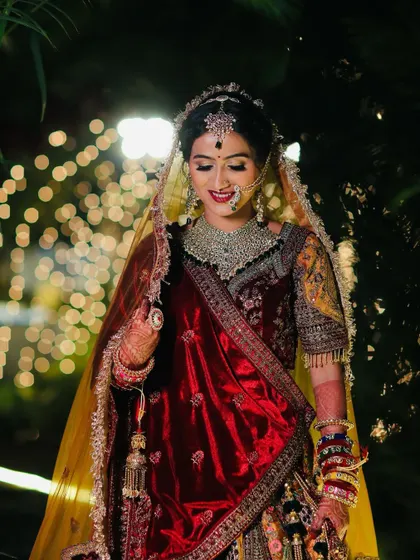 A candid moment of the bride adjusting her veil, with a soft smile that lights up her face.