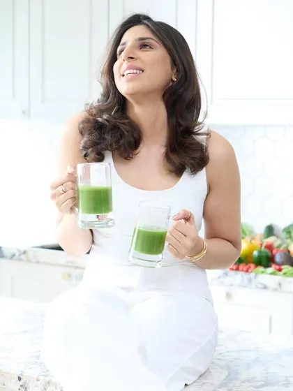 A lifestyle shot showing the dietitian enjoying a healthy green juice. Branding photos should showcase your service in action, and this image communicates health and wellness perfectly.