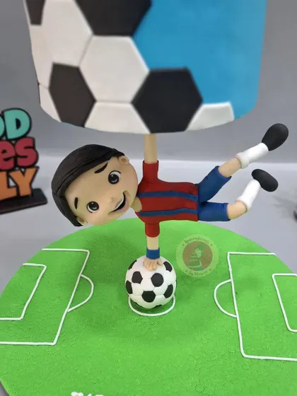 A close-up of the anti-gravity football cake, a design we teach in our specialized masterclass.