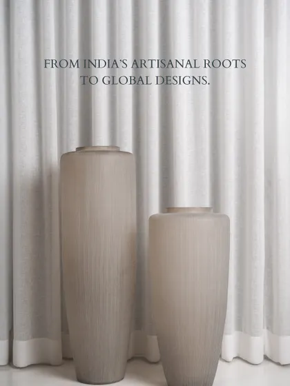 These tall, fluted glass vases are beautifully grounded against a soft curtain backdrop. Their subtle texture and translucent quality create a serene and elegant statement, perfect for a quiet corner of your world.