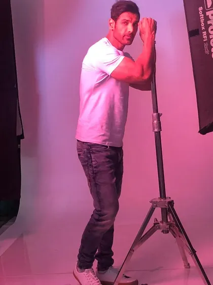 A candid moment with John Abraham during a studio photoshoot. My job often involves being on hand to make sure everything looks perfect for the camera.