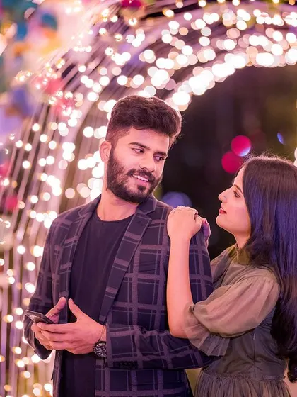 A candid moment within a tunnel of colorful lights. The soft focus and beautiful bokeh effect create a dreamy and intimate atmosphere for this pre-wedding photo.