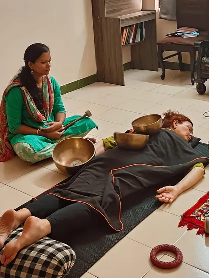 A student practices a therapeutic bowl placement technique during our Level 2 training. This advanced course delves into more specific protocols for using sound to address physical and emotional imbalances.