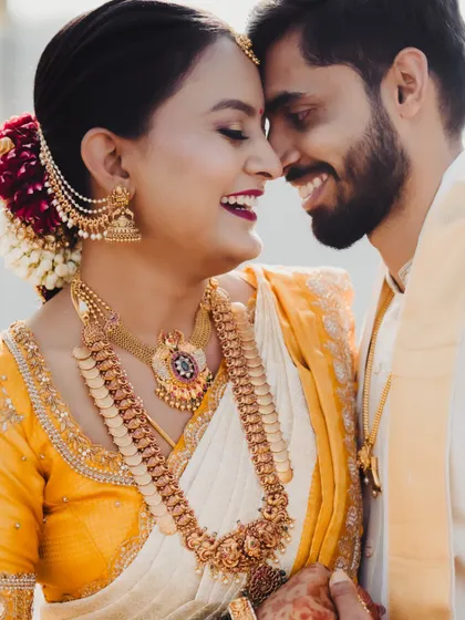 The pure joy on the bride's face says it all. This candid shot captures a happy, intimate moment between the couple, reflecting the love and happiness of their wedding day.