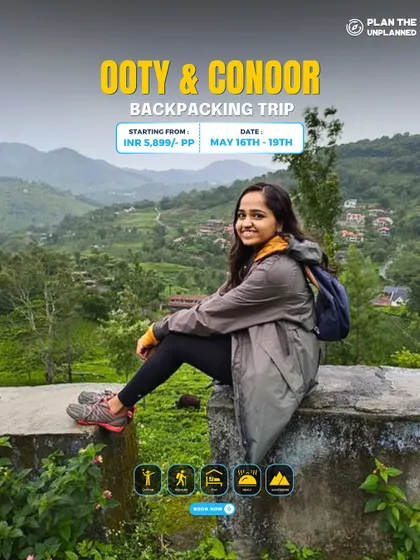 A solo traveler enjoying the view from a wall on our Ooty & Coonoor trip. It's a perfect blend of sightseeing and relaxation.