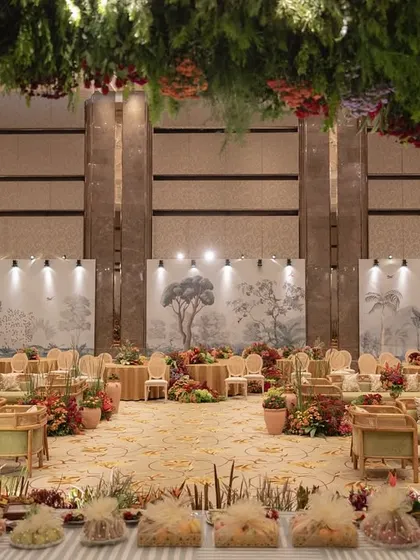 A wide view of the 'Orchard of Life' hall, with seating arranged around the central floral trees.
