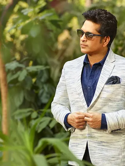 Photographing an icon like Sachin Tendulkar requires capturing both the sportsman and the gentleman. This portrait, set against a natural backdrop, showcases his dapper style and calm, focused demeanor off the field.