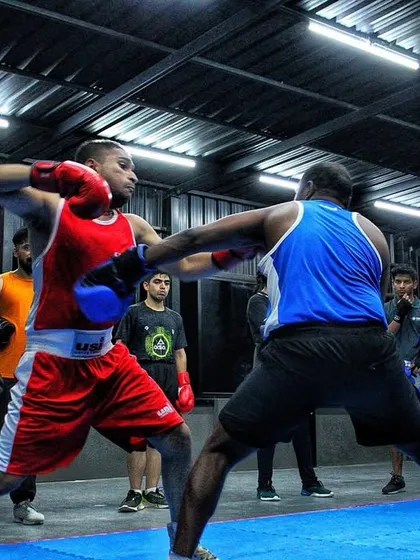 An explosive moment during sparring day. Both fighters are fully engaged, showing the results of their hard training in every punch.