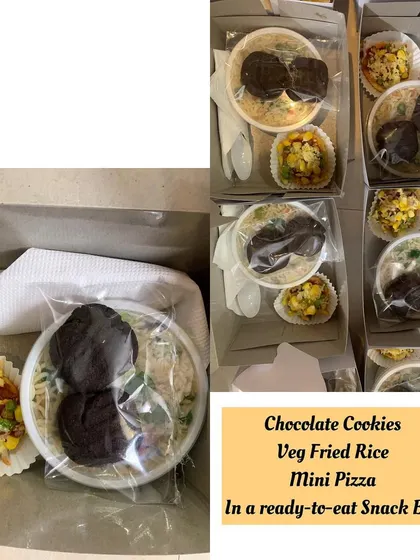 Simple and delightful ready to eat snack boxes. Each box contains Veg Fried Rice, a mini pizza, and delicious chocolate cookies for a perfect little treat.