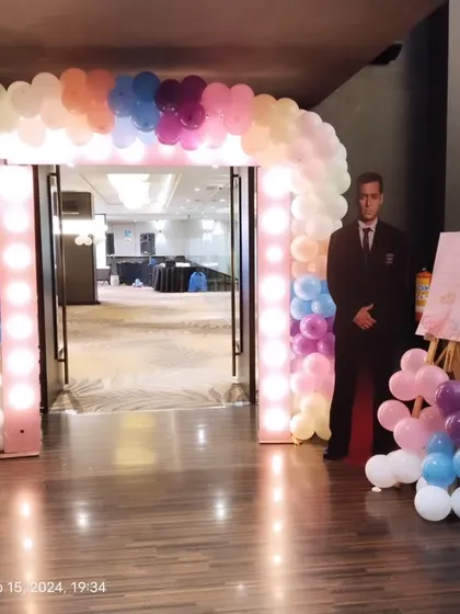 An illuminated balloon arch creates a grand entrance for any corporate gala or party. The pastel color palette and integrated lights provide a warm and inviting welcome.