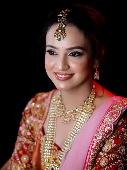 A stunning close-up of the bride-to-be. The makeup is focused on creating a flawless, glowing complexion that looks incredible on camera.