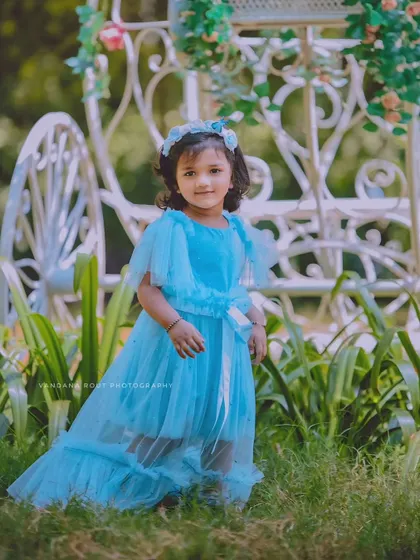 Another shot of our little Cinderella, this time with a beautiful white carriage prop in the background. The entire setup is designed to create a fairytale atmosphere.