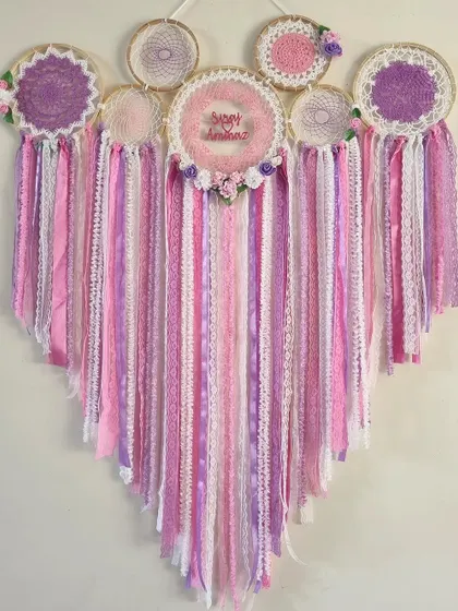 This heart-shaped cluster dreamcatcher in shades of pink and purple is a statement of love. It's a perfect backdrop for events or a stunning centerpiece in a living room.