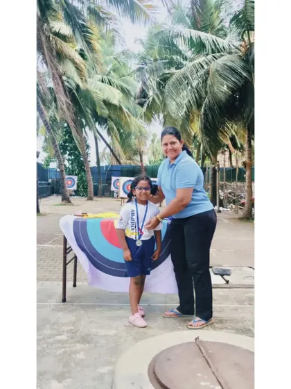 A young girl smiles as she receives her medal. Our intraclub events are designed to be encouraging and positive for all.