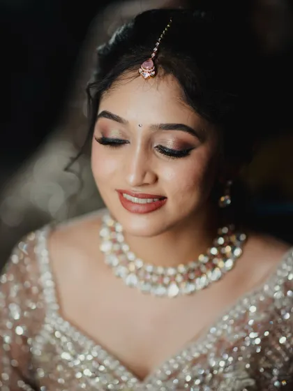 A close-up on the bride's soft glam makeup. The focus is on her eyes, with long lashes and perfectly blended shadow.