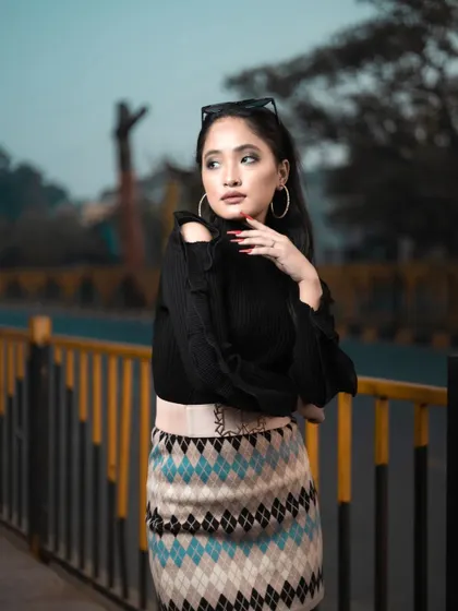 A close-up of the model from the winter shoot, showing the clean makeup, defined brows, and simple hairstyle that complete this chic look.