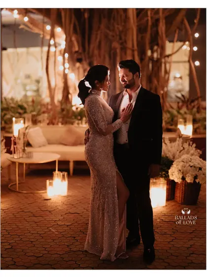 Creating a romantic and cozy atmosphere with soft, delicate lighting. The couple is surrounded by dozens of candles, casting a warm glow that is perfect for intimate reception photos.