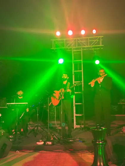 Green lights wash over our musicians as the Golfshire outdoor performance brings flute and guitar into the same song.