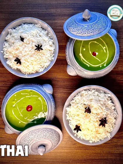 A beautiful presentation of our Thai Green Curry and rice, showcasing one of the many Pan-Asian dishes we offer for house parties and events.