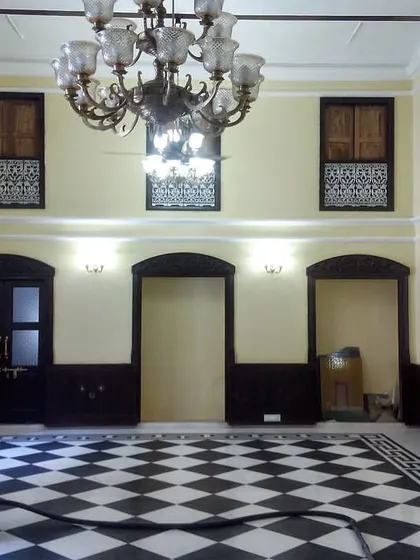 The haveli hall nearing completion. The walls have been replastered and painted, the flooring is complete, and the electrical work is being finalized, showcasing the dramatic transformation from neglect to elegance.